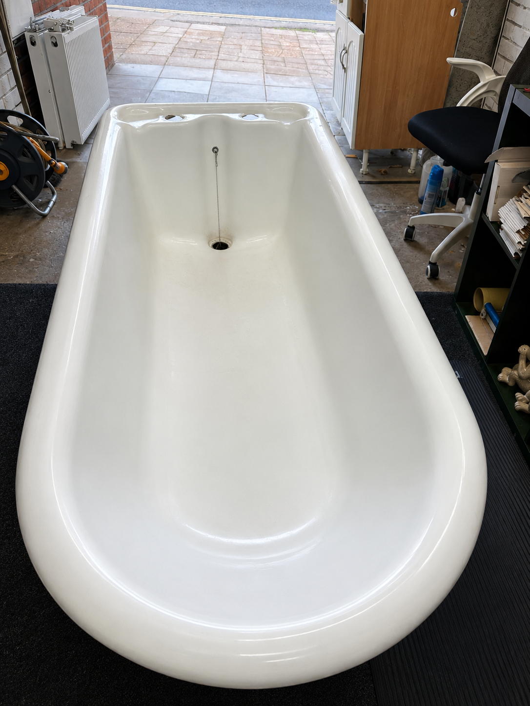 Original Victorian steel roll top bath before installation in Brentwood, Essex