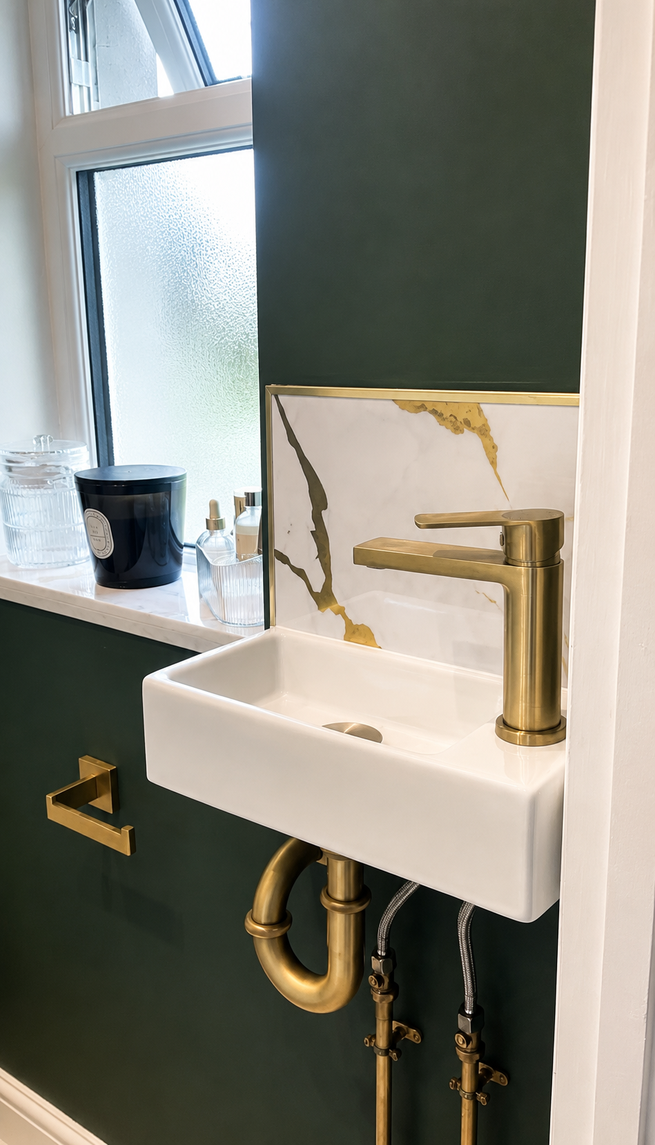 Compact wall-mounted basin with brushed brass tap, waste and trap in a Billericay bathroom renovation