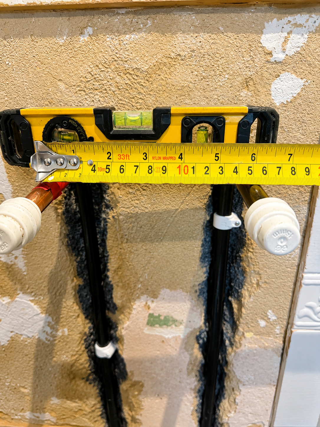 Hot and cold pipework chased into the wall and levelled for an exposed thermostatic shower valve in Basildon